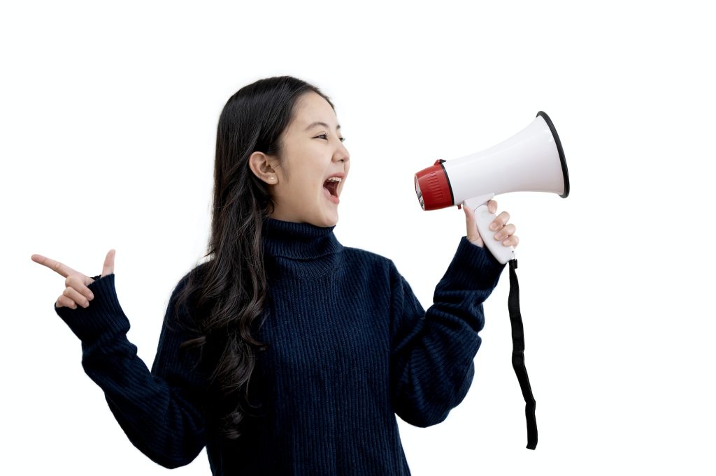 Beautiful Asian Girl Using Megaphone For Announcement, Cheerful caucasian Woman Holding Loudspeaker