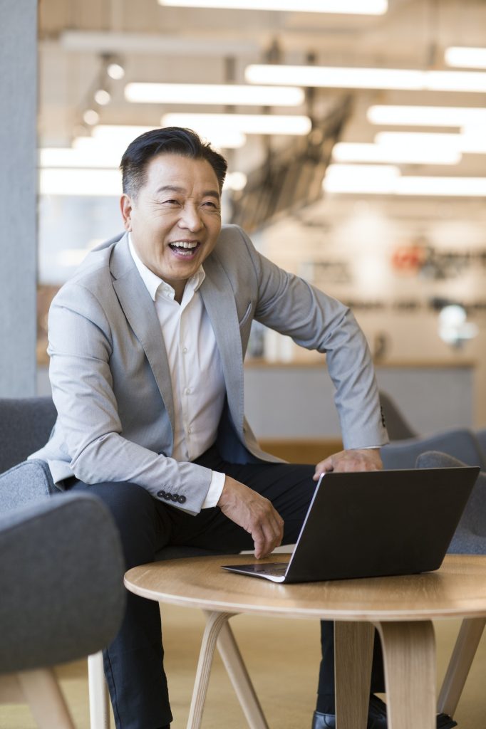 Confident businessman using laptop